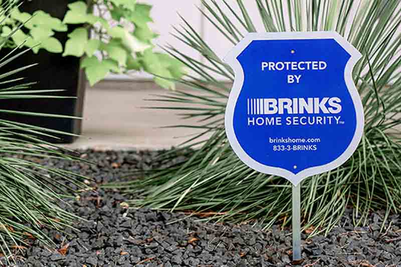 Intulse helps a national home security company through VoIP, Unified Communication, and integration with their CRM. An image of a Brinks Home Security sign in a front yard.