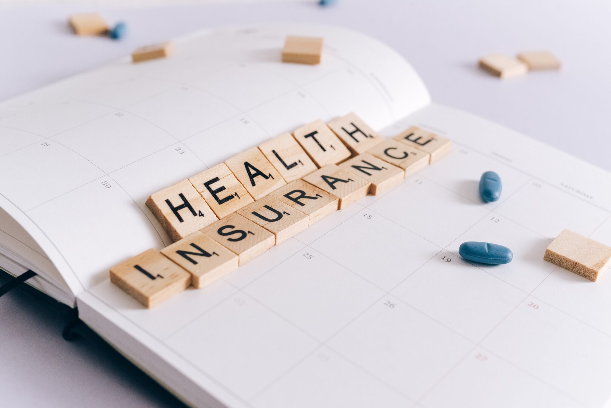 2024 CMS Final Rule clarifications, an image of health insurance spelled out with scrabble tiles
