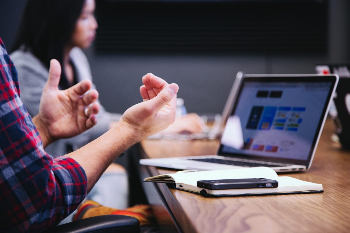 Preparing your business for an emergency with cloud-based, unified communications. Image of two men discussing a mobile phone