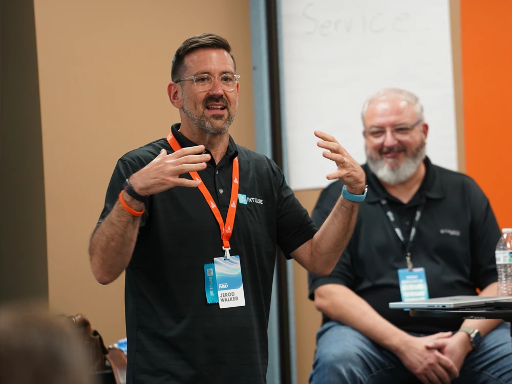 Photo of some Intulse employees speaking at a parter event